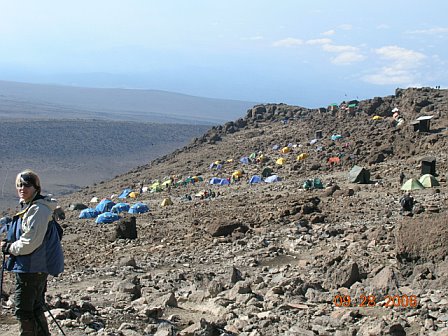 Tents set up on the rocky slopes of Mount Kilimanjaro during a trekking expedition.