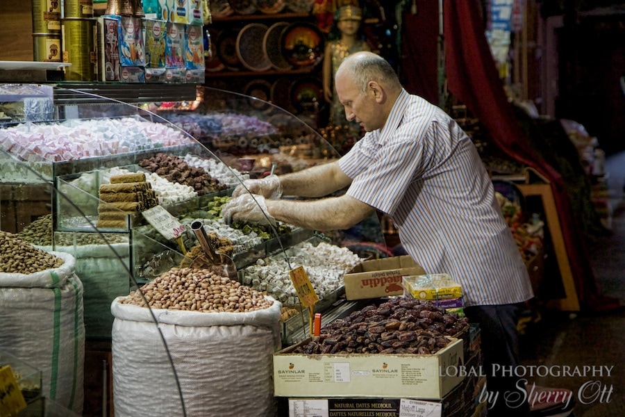 man replenishes inventory in the spice market