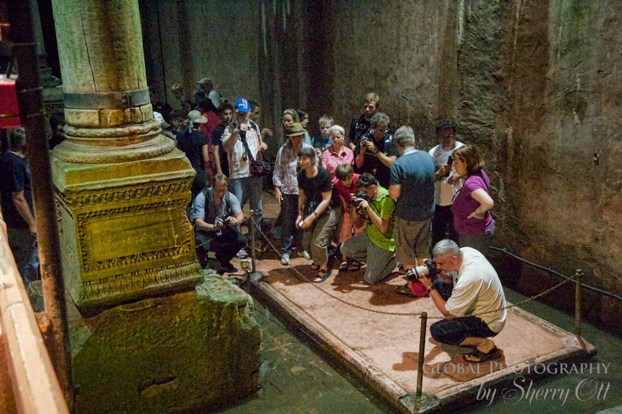 Tourists crowd around Medusa to snap a photo