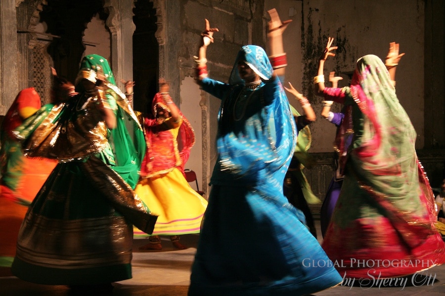 Indian women dance in colorful scarves in Udaipur