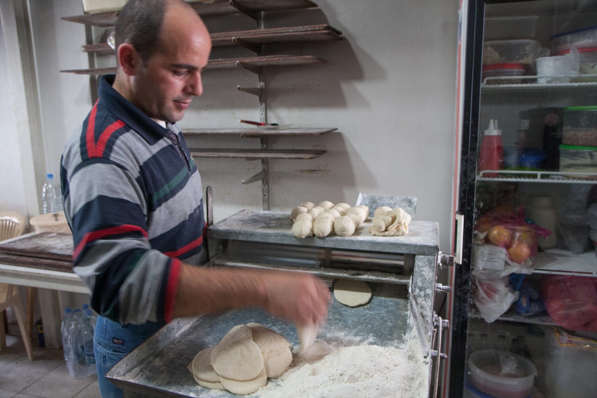 Lebanese shop owner making bread