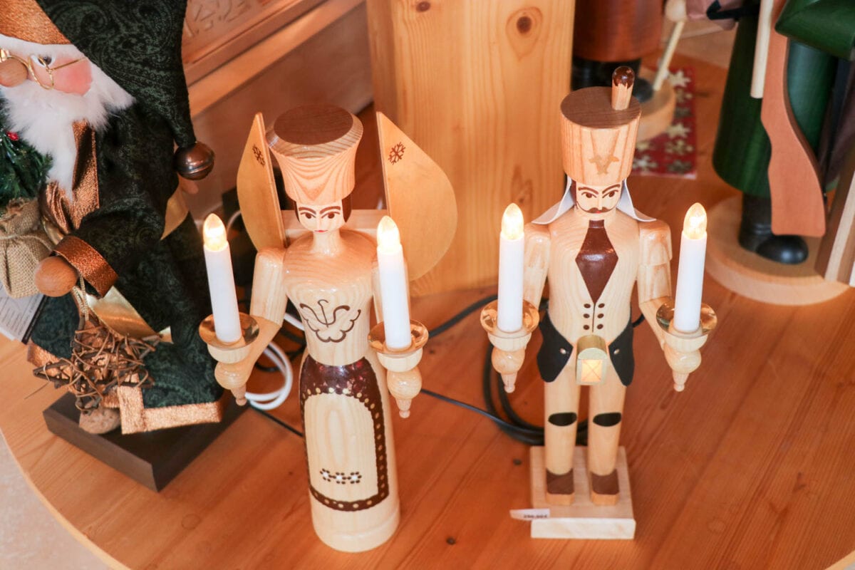 Two nutcracker dolls holding candles