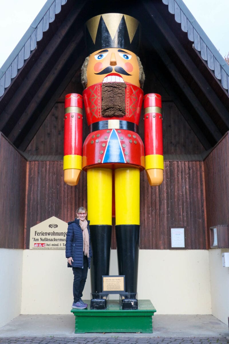 Author stands next to giant nutcracker