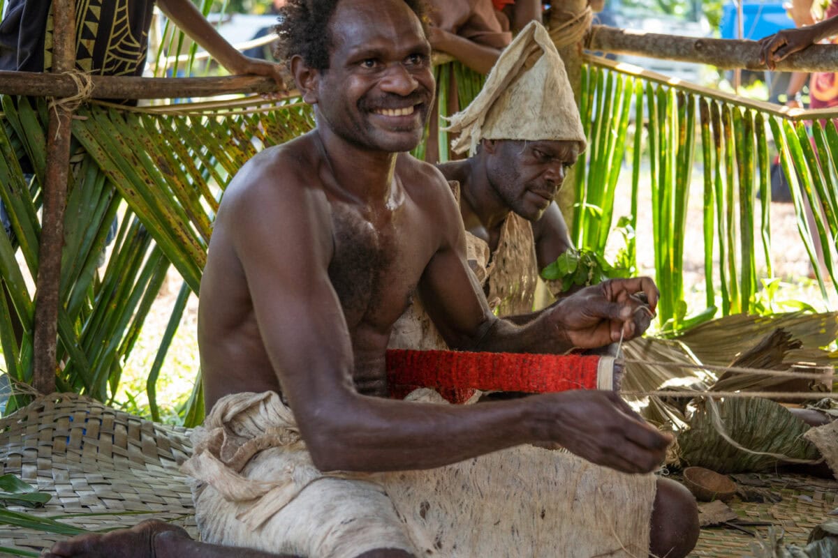 constructing a red feather hat South Pacific