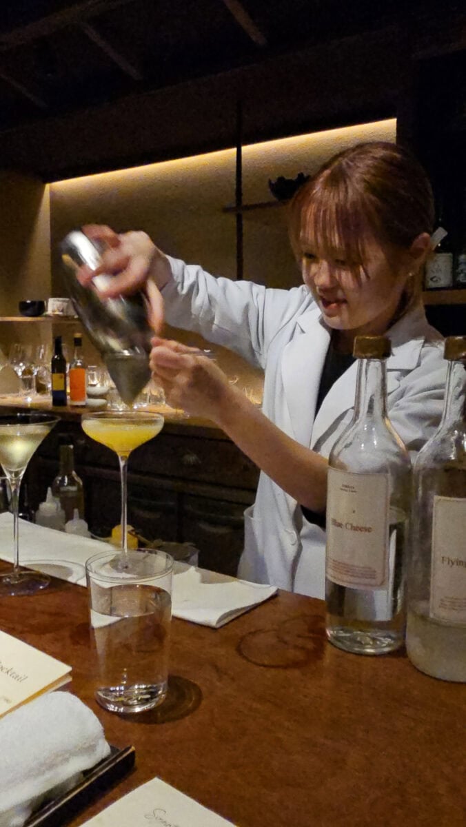 Bartender pouring a cocktail at a bar in Japan's hidden shot bars, showcasing precise cocktail craftsmanship.