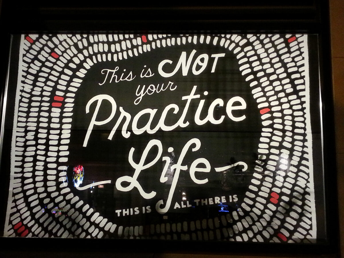 Inspirational quote on practice and life with a black background and white dotted border.